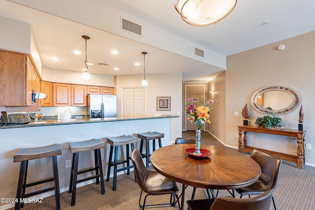 dining space with light carpet