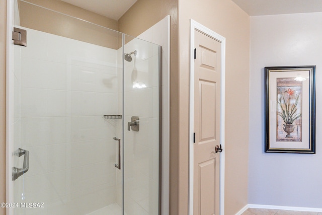 bathroom with a shower with shower door