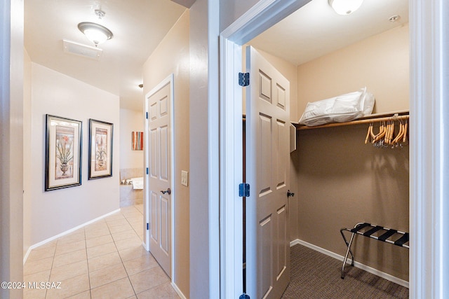 hallway featuring light tile floors