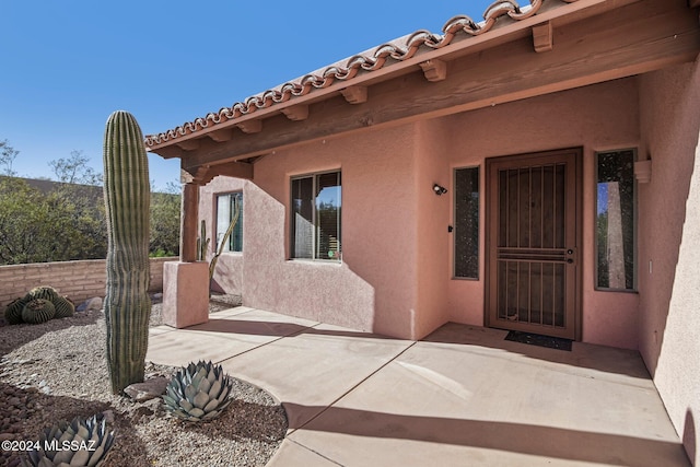 property entrance with a patio area