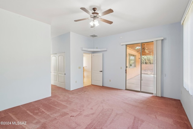 unfurnished bedroom featuring access to exterior, light colored carpet, and ceiling fan