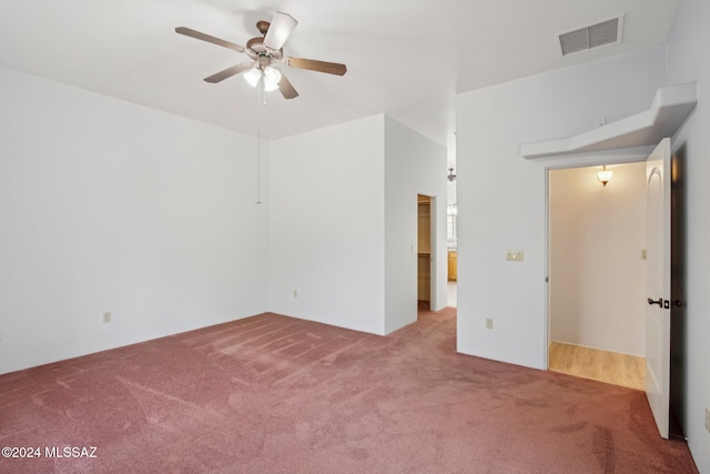 empty room with carpet flooring and ceiling fan