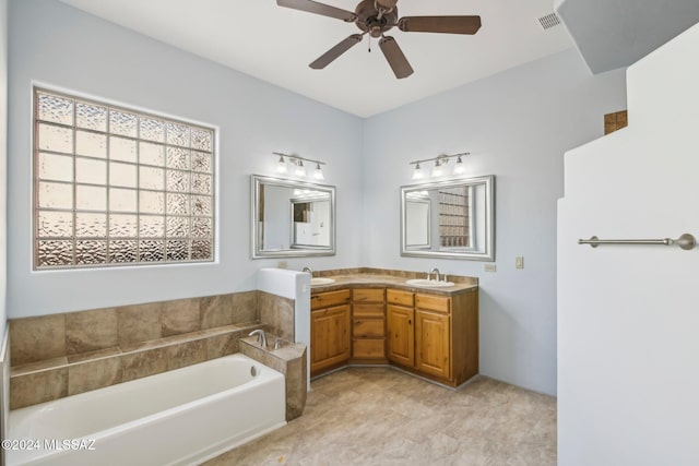 bathroom with vanity, a bathtub, and ceiling fan