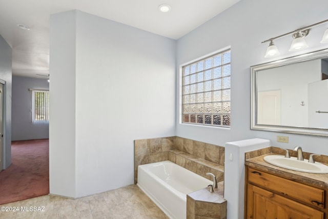 bathroom with vanity and a tub