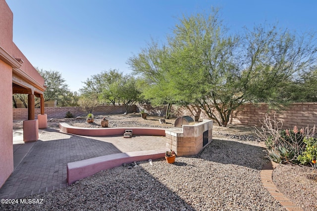 view of yard with a patio area and an outdoor kitchen