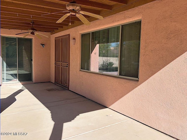 property entrance featuring a patio and ceiling fan