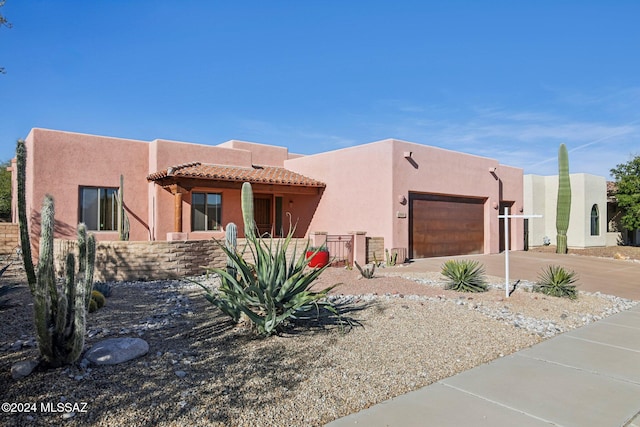 pueblo-style house with a garage