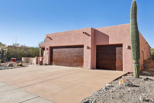 pueblo-style home featuring a garage