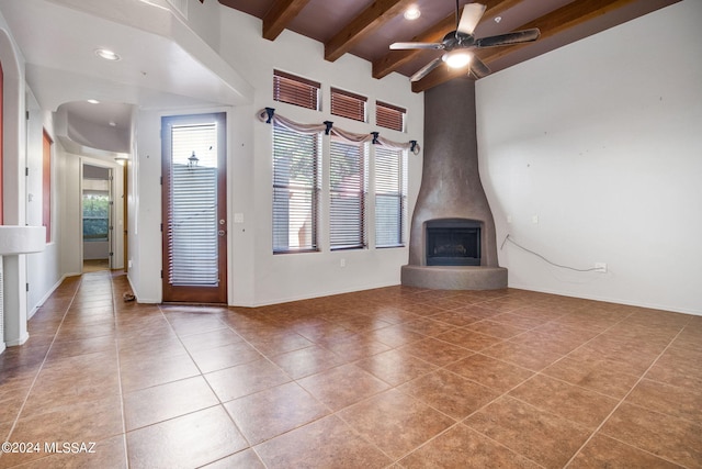 unfurnished living room with tile flooring, ceiling fan, and a wealth of natural light