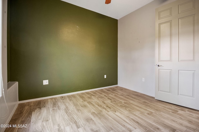 empty room with light wood-type flooring and ceiling fan