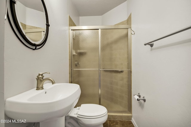 bathroom with sink, tile flooring, an enclosed shower, and toilet