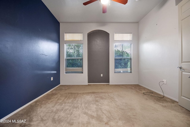 empty room featuring ceiling fan and carpet floors