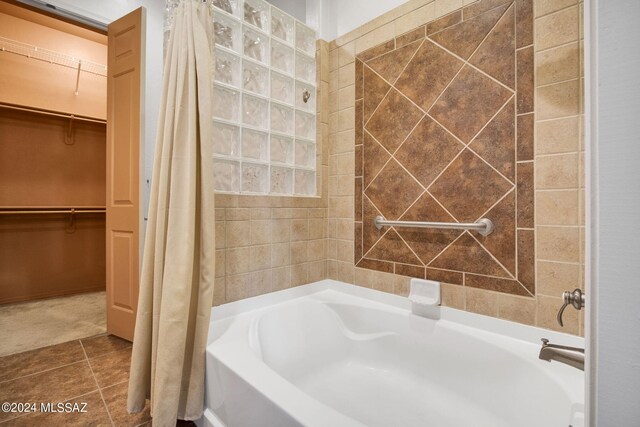 bathroom featuring tile flooring and shower / tub combo with curtain