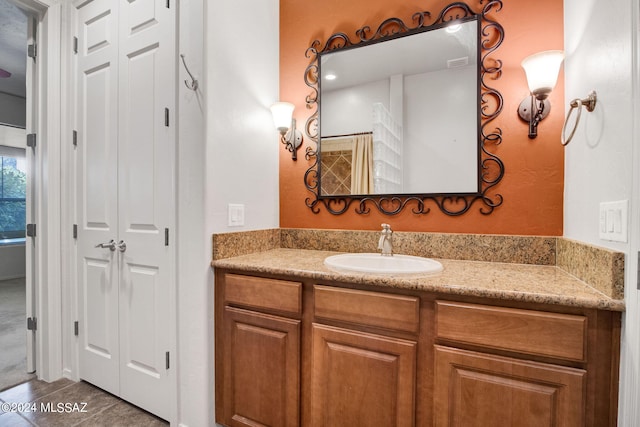 bathroom featuring tile flooring and vanity