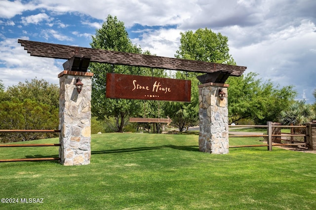 community sign featuring a lawn