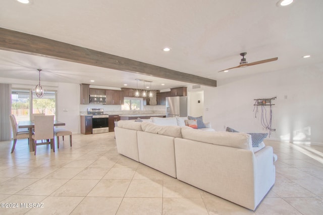 living room with ceiling fan, beam ceiling, and light tile patterned floors