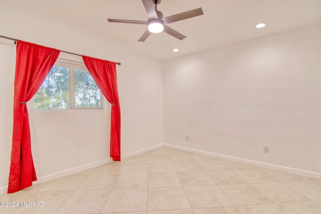 tiled spare room with ceiling fan