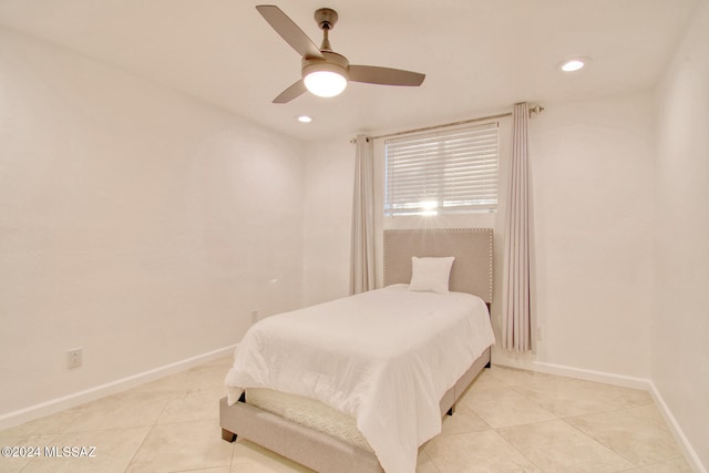 tiled bedroom featuring ceiling fan