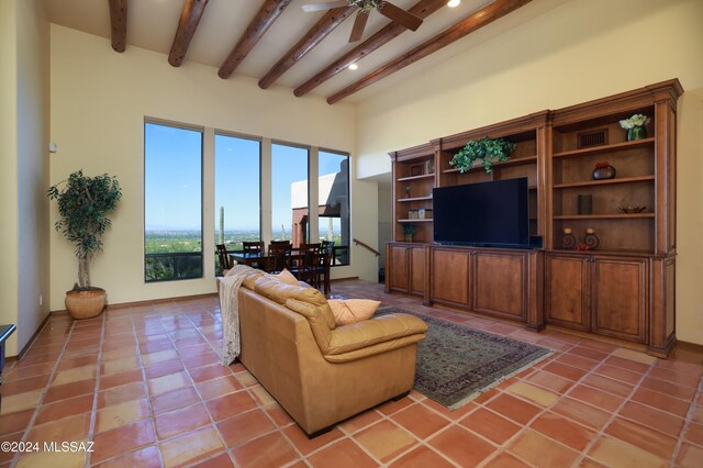 tiled living room with beam ceiling and ceiling fan