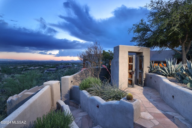 view of patio terrace at dusk