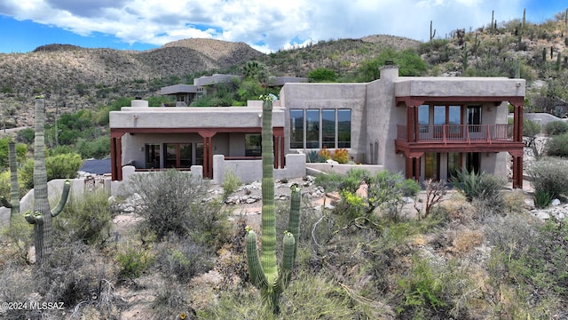 rear view of house featuring a mountain view