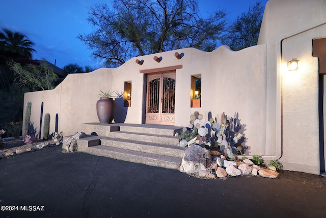 view of exterior entry at dusk