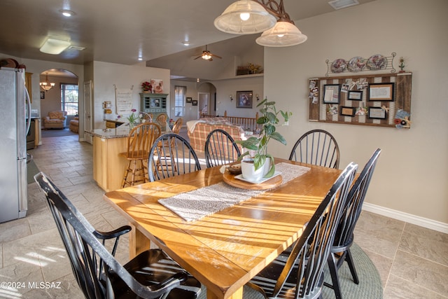 tiled dining space with ceiling fan