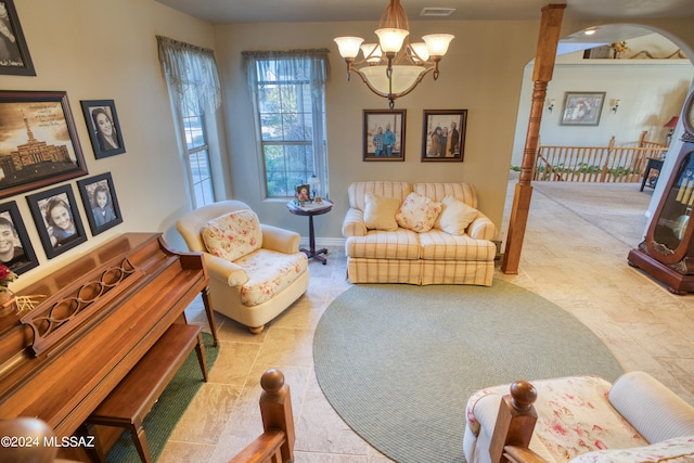 living room with a chandelier and tile floors