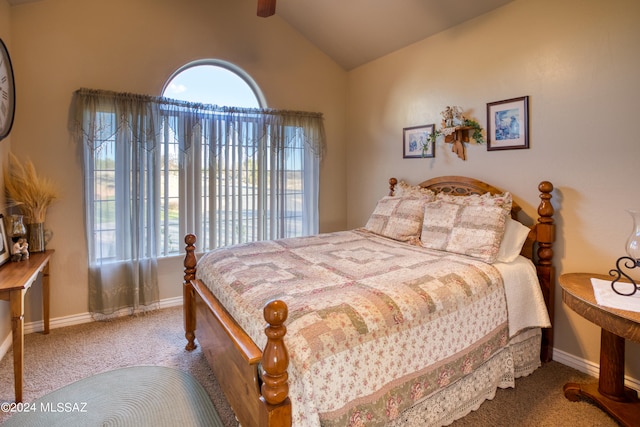 carpeted bedroom with vaulted ceiling and multiple windows