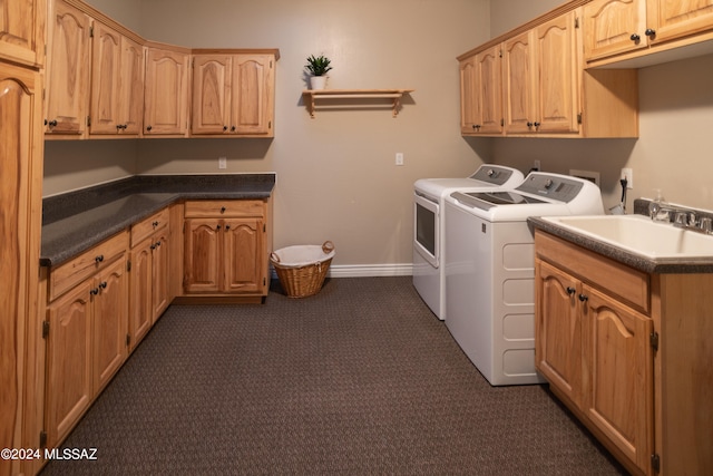 laundry area with cabinets, separate washer and dryer, dark carpet, and sink