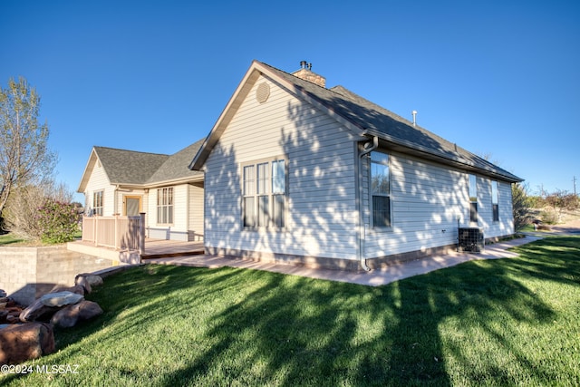 view of home's exterior featuring a yard and a wooden deck