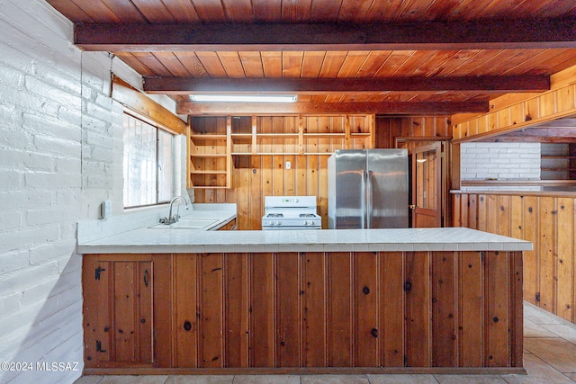 kitchen with wooden ceiling, white stove, beam ceiling, stainless steel refrigerator, and sink