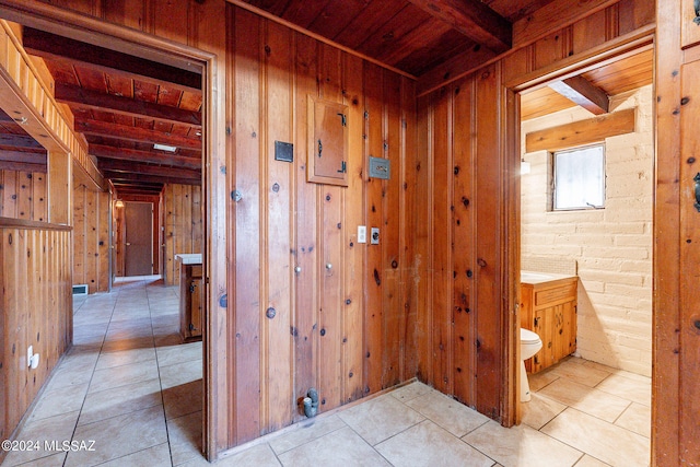 bathroom featuring beamed ceiling, tile floors, wood ceiling, and toilet