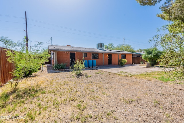 back of house with central AC unit