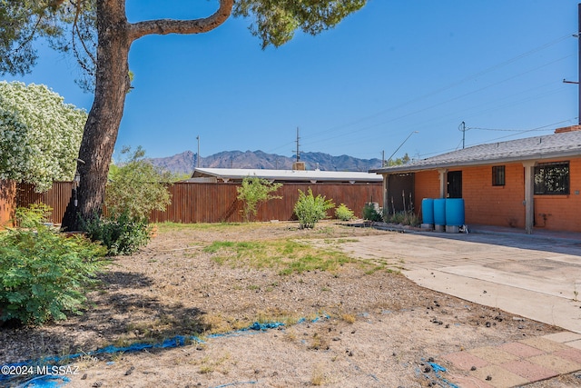 view of yard featuring a patio area and a mountain view