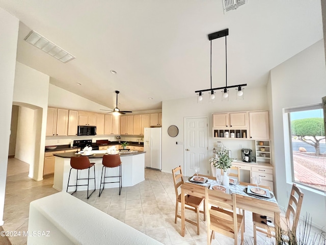 kitchen featuring lofted ceiling, a center island, pendant lighting, white refrigerator with ice dispenser, and stove