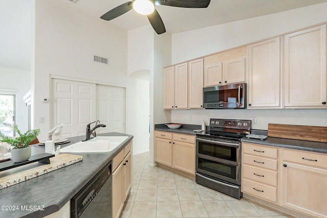 kitchen with sink, light tile patterned floors, ceiling fan, stainless steel appliances, and light brown cabinets