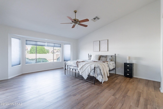 bedroom featuring hardwood / wood-style flooring, ceiling fan, and lofted ceiling