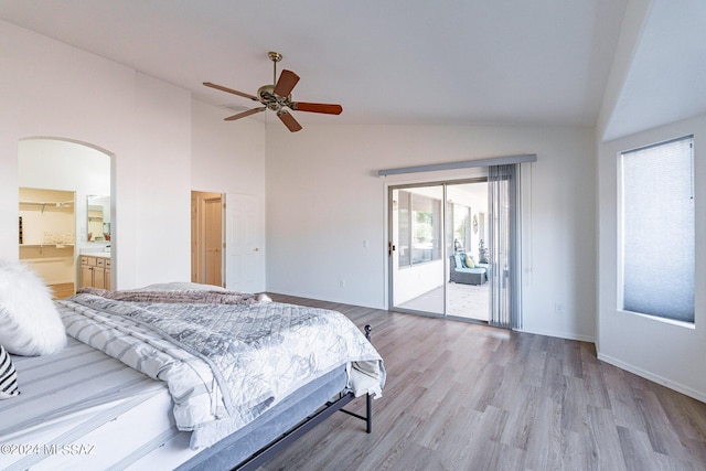 bedroom with a ceiling fan, baseboards, light wood-style flooring, arched walkways, and access to exterior