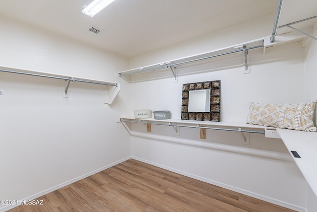 walk in closet featuring visible vents and light wood finished floors