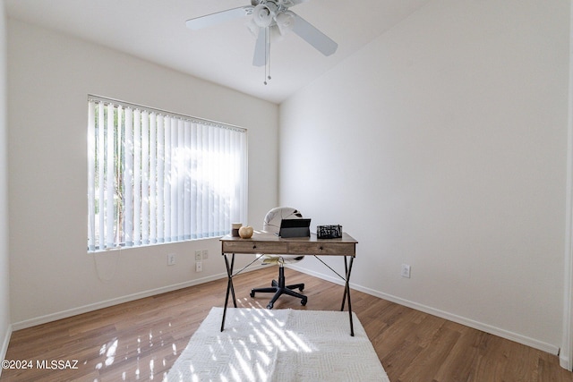 home office with ceiling fan, lofted ceiling, and light wood-type flooring