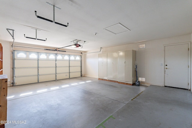 garage with a garage door opener and baseboards