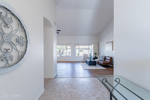 tiled living room featuring lofted ceiling