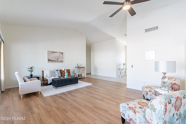 living area featuring visible vents, high vaulted ceiling, a ceiling fan, and light wood finished floors