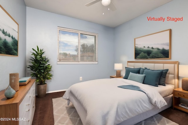 bedroom featuring ceiling fan and dark wood-type flooring