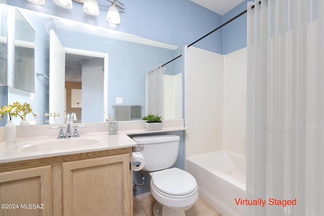 full bathroom with tile patterned flooring, shower / bath combo with shower curtain, vanity, and toilet