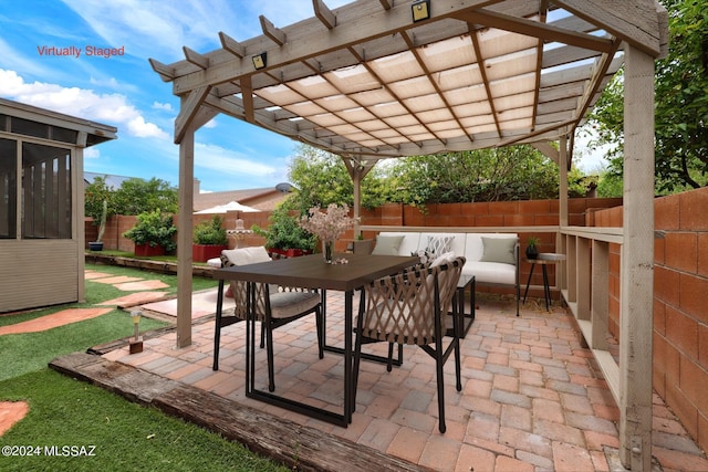 view of patio / terrace with a pergola, an outdoor hangout area, and a sunroom