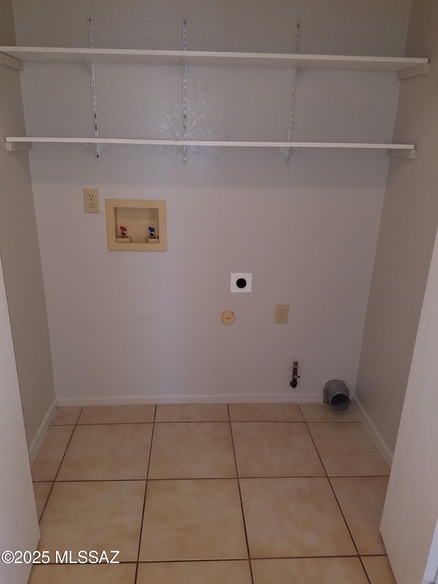 laundry room featuring gas dryer hookup, light tile patterned floors, washer hookup, and hookup for an electric dryer