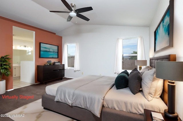 tiled bedroom with ensuite bath, ceiling fan, and lofted ceiling