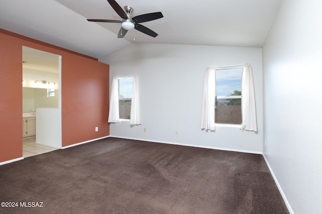 spare room with ceiling fan, plenty of natural light, light colored carpet, and lofted ceiling